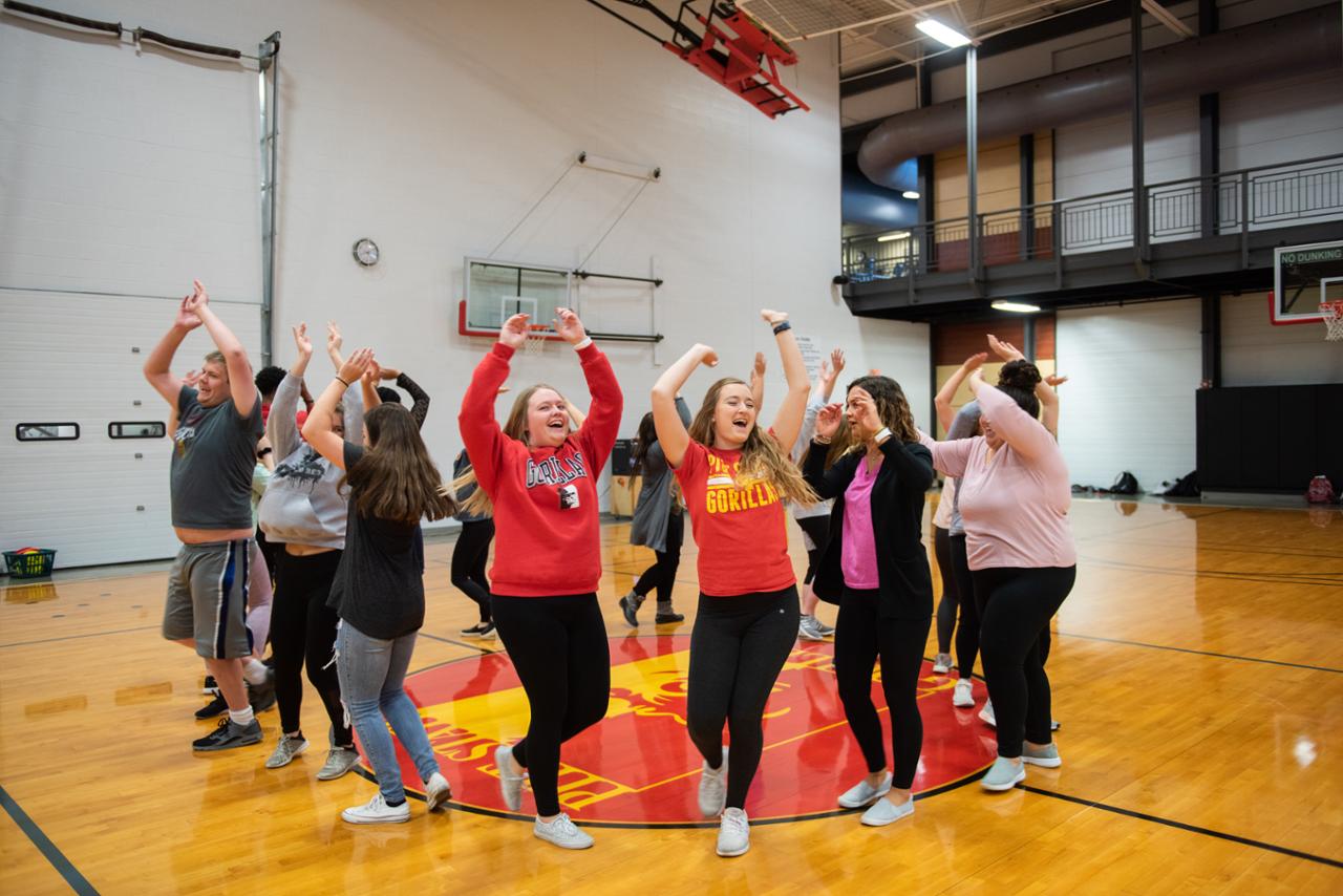 students in a circle performing a movement activity