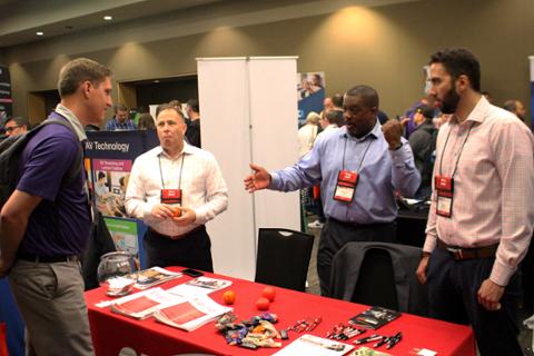 CHECK sponsors at their booth telling others about the latest and greatest that their company has to offer.