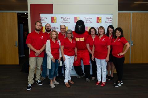 Gus the Gorilla and all the members of the CHECK committee smiling for the camera.