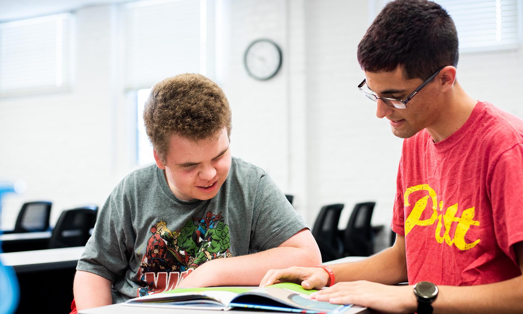 Student helping student to read