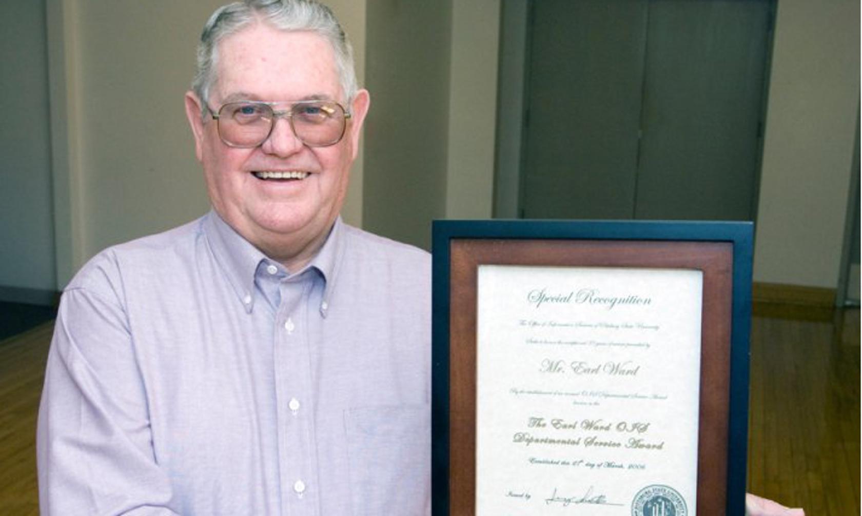 Earl Ward with recognition plaque