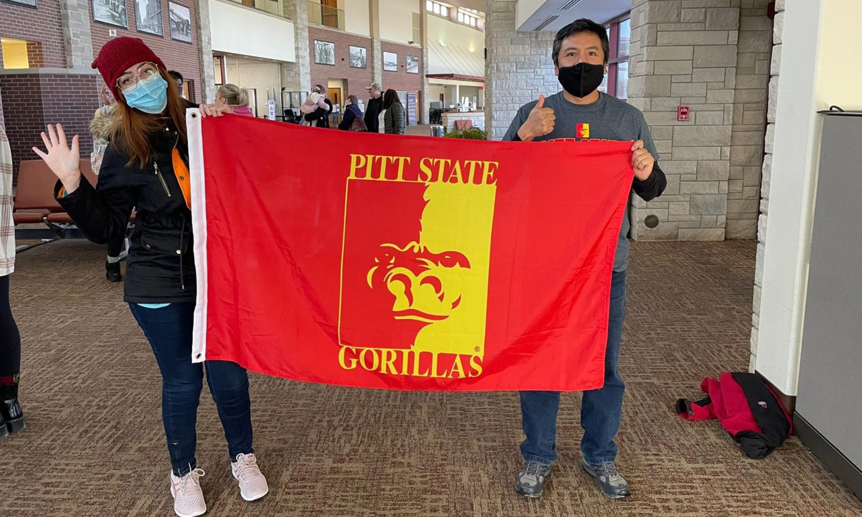 international students at airport with flag