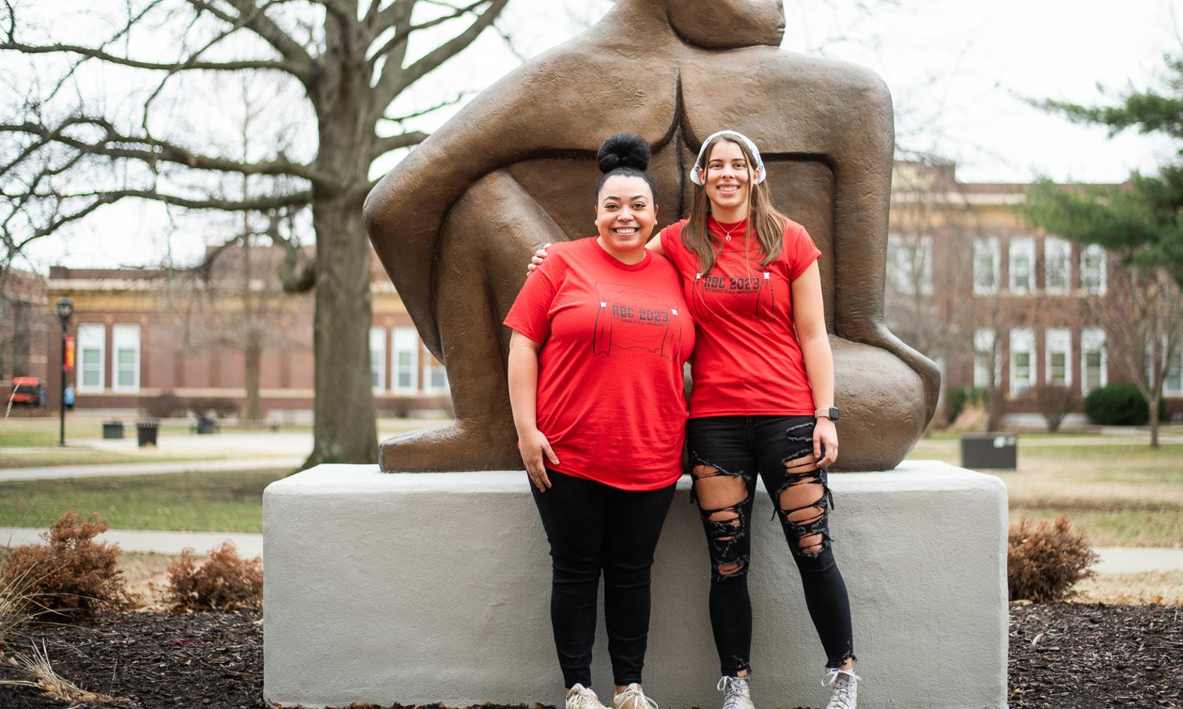 Student leaders in front of Gorilla statue