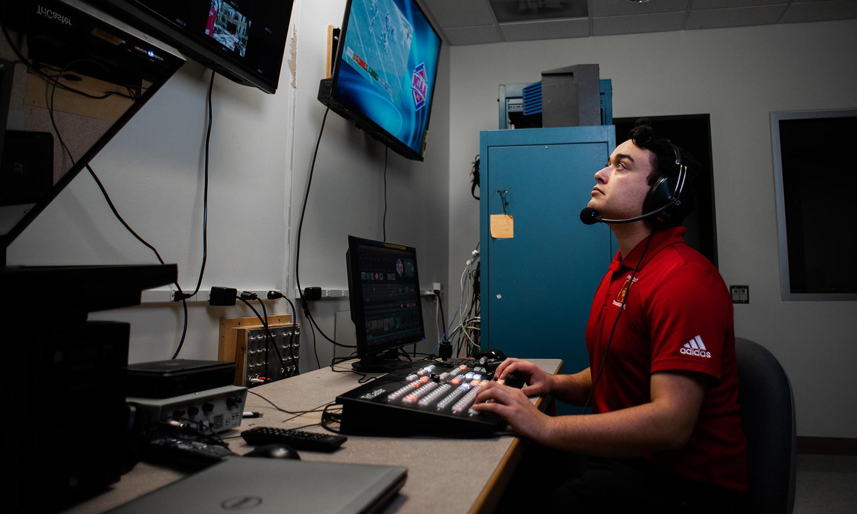 Broadcasting student looking at monitors