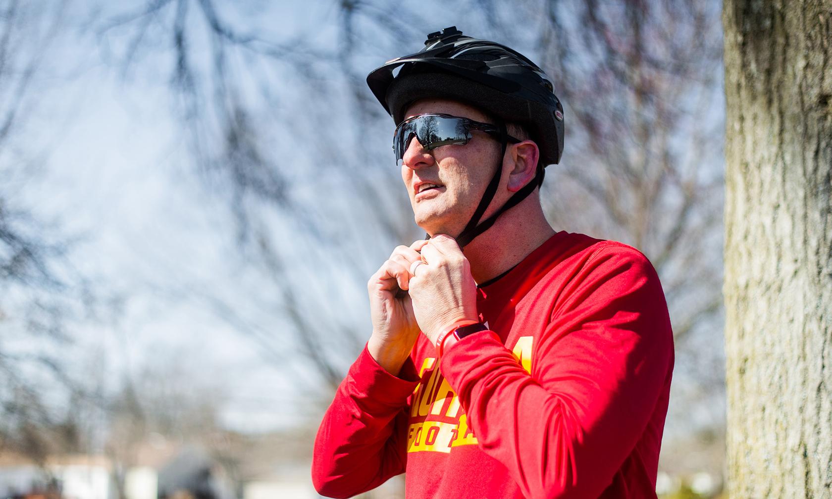 Dan Shipp putting on a bike helmet