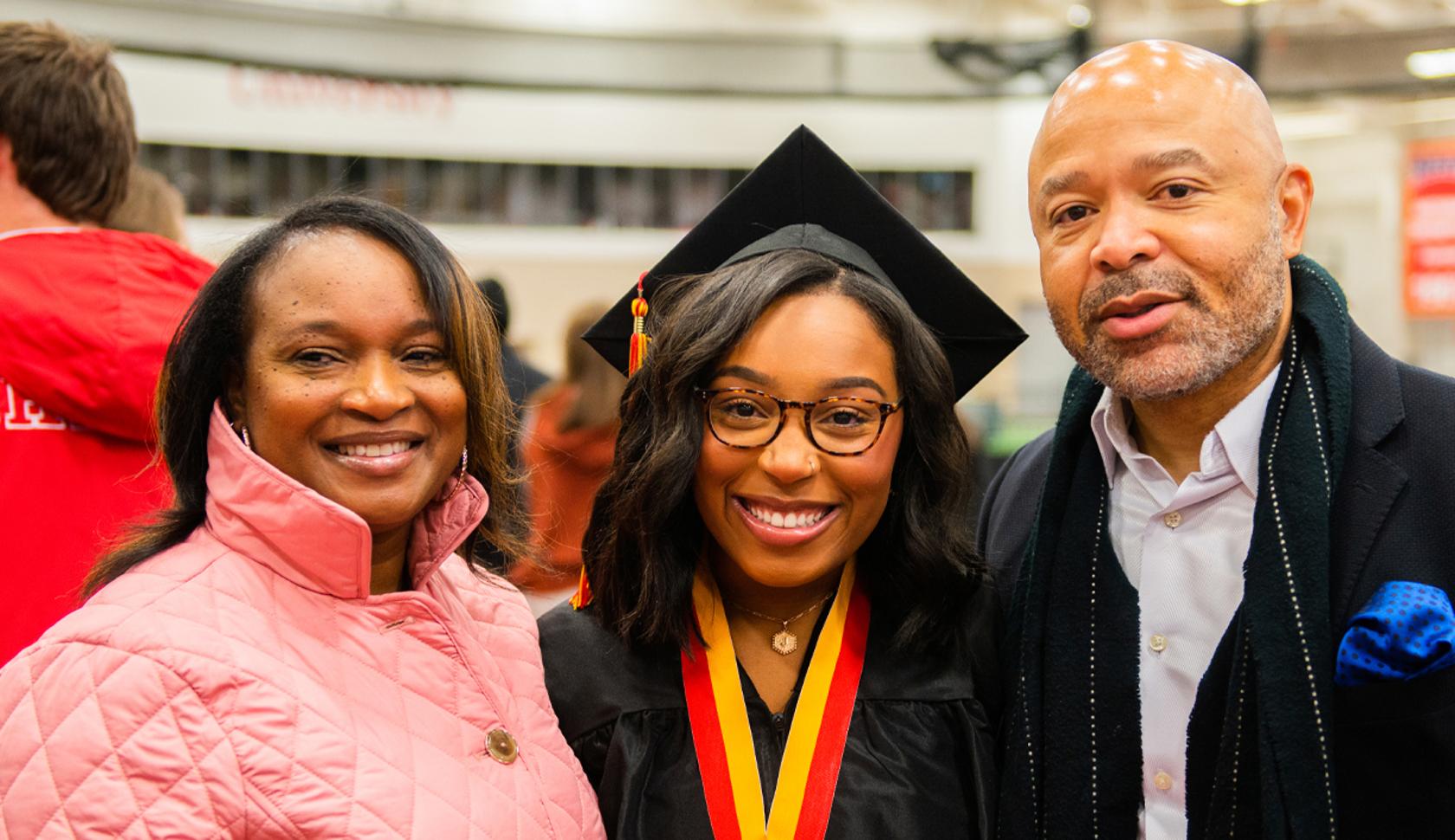 Commencement graduate with parents