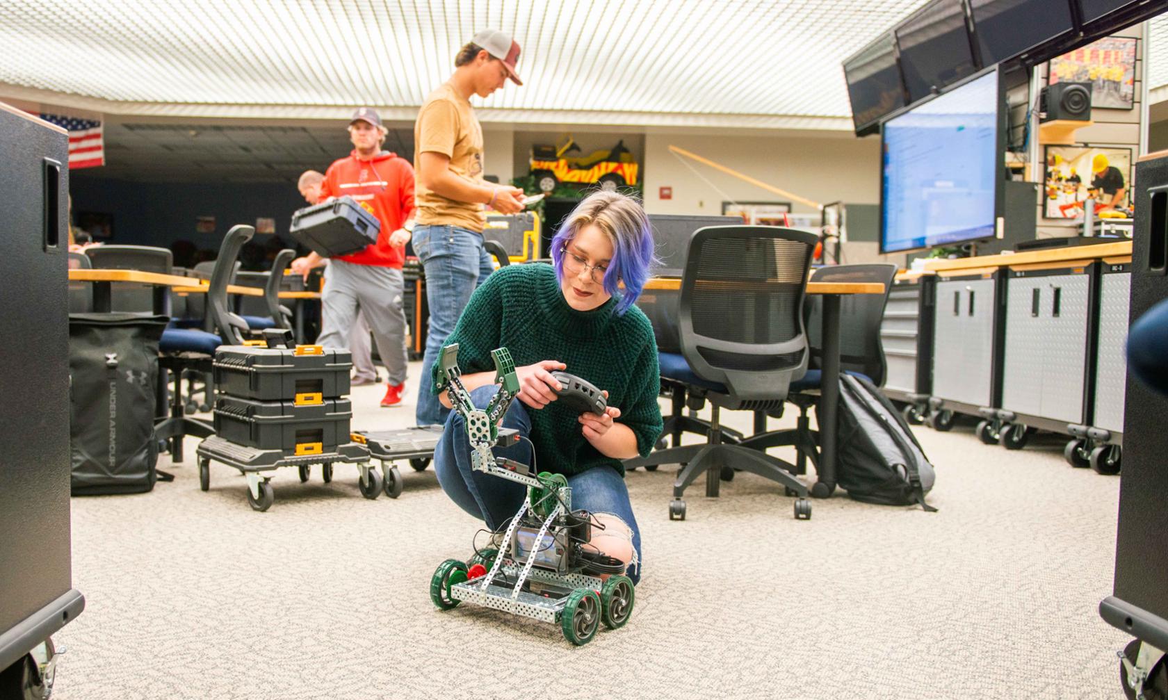 student working with robot in STEM lab