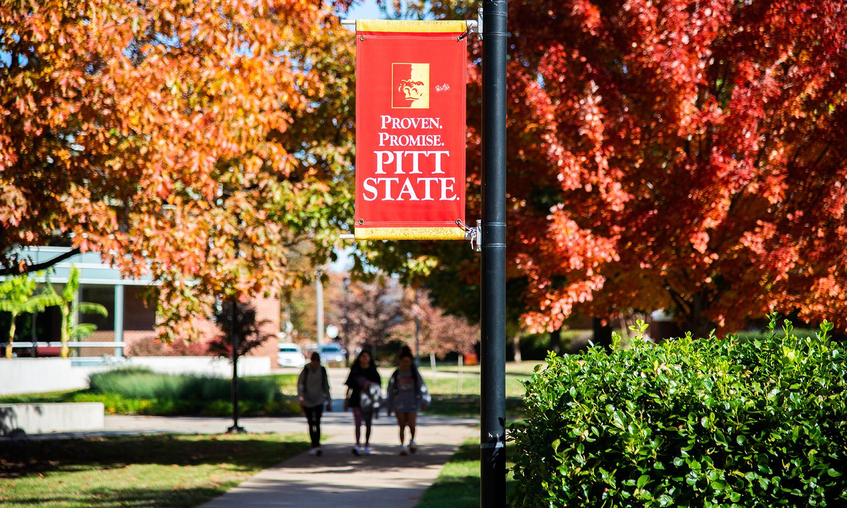 Fall leaves on campus and a Pitt State banner