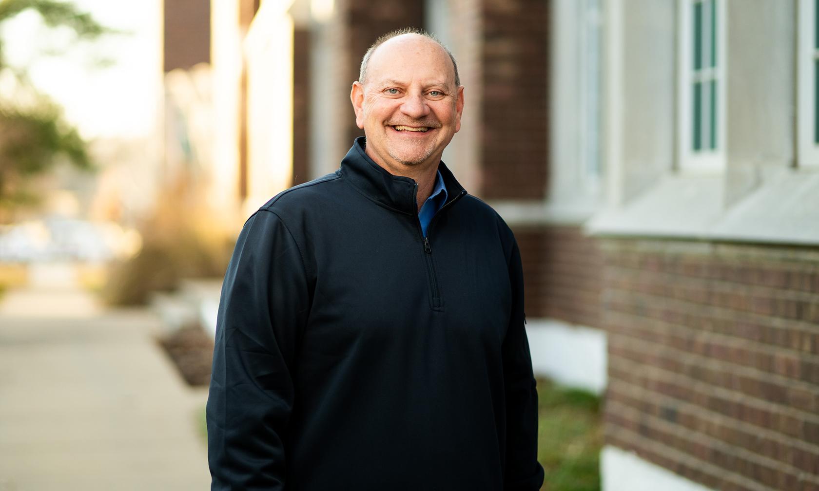 David Hogard, director of admission, standing outside