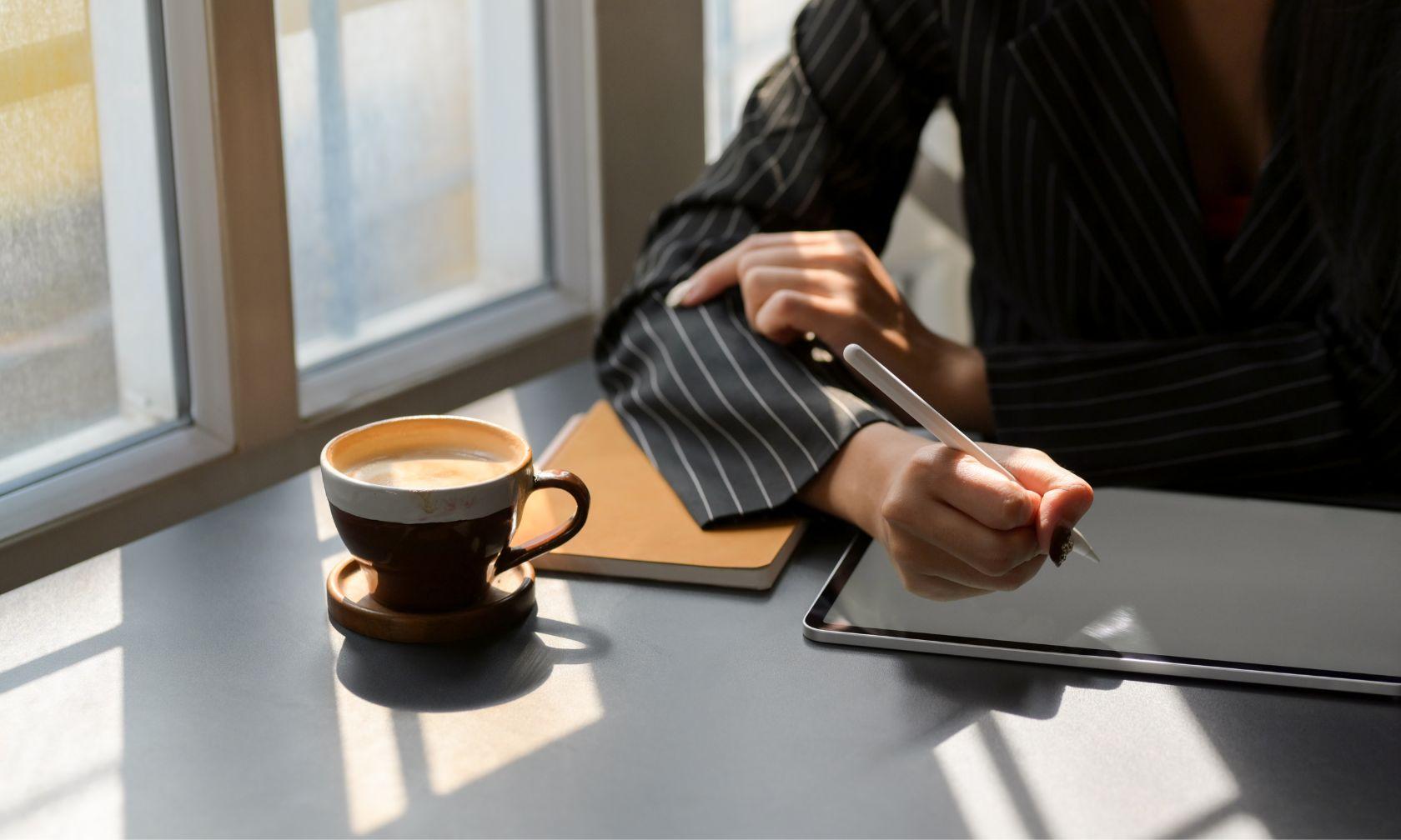 entrepreneur with notepad, pencil, and coffee