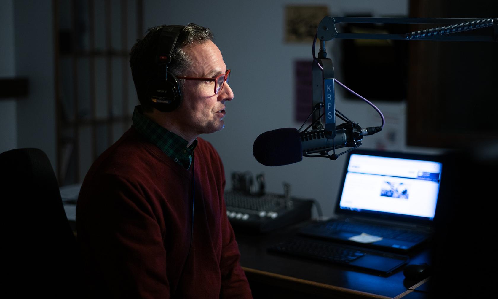 Radio station announcer at microphone