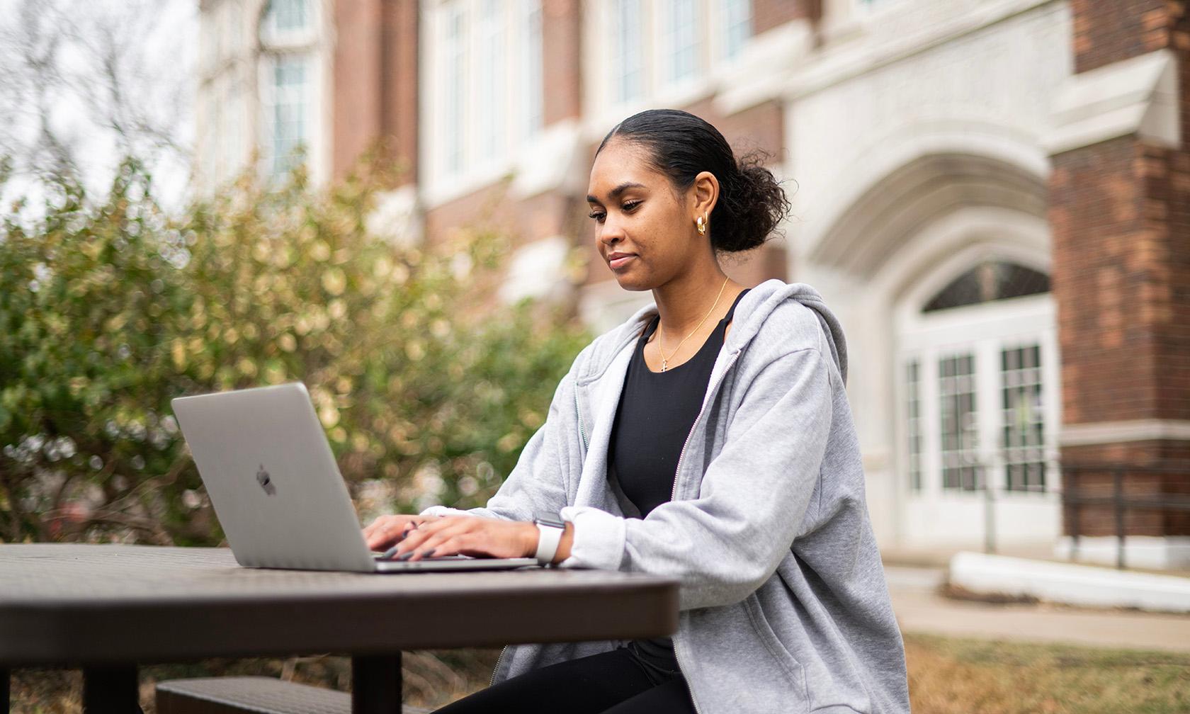 student looking at laptop