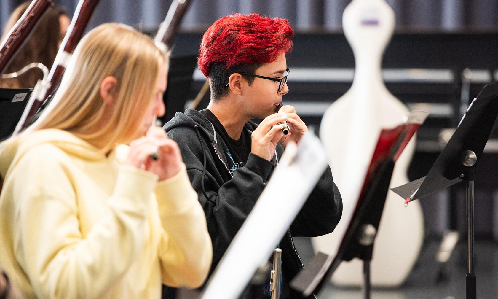 Student playing flute at band rehearsal