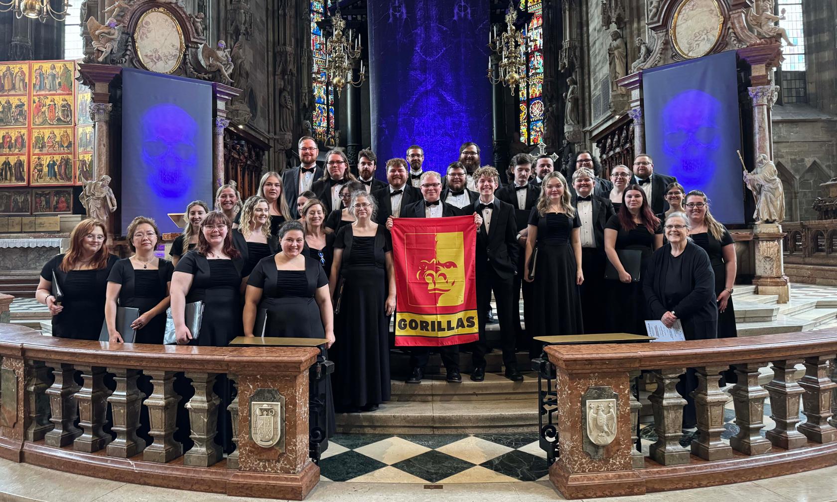 Students with Pitt State banner in cathedral