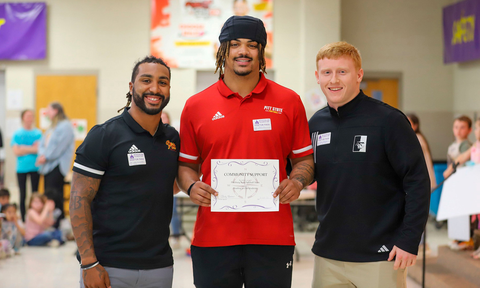 Football players and staff with award