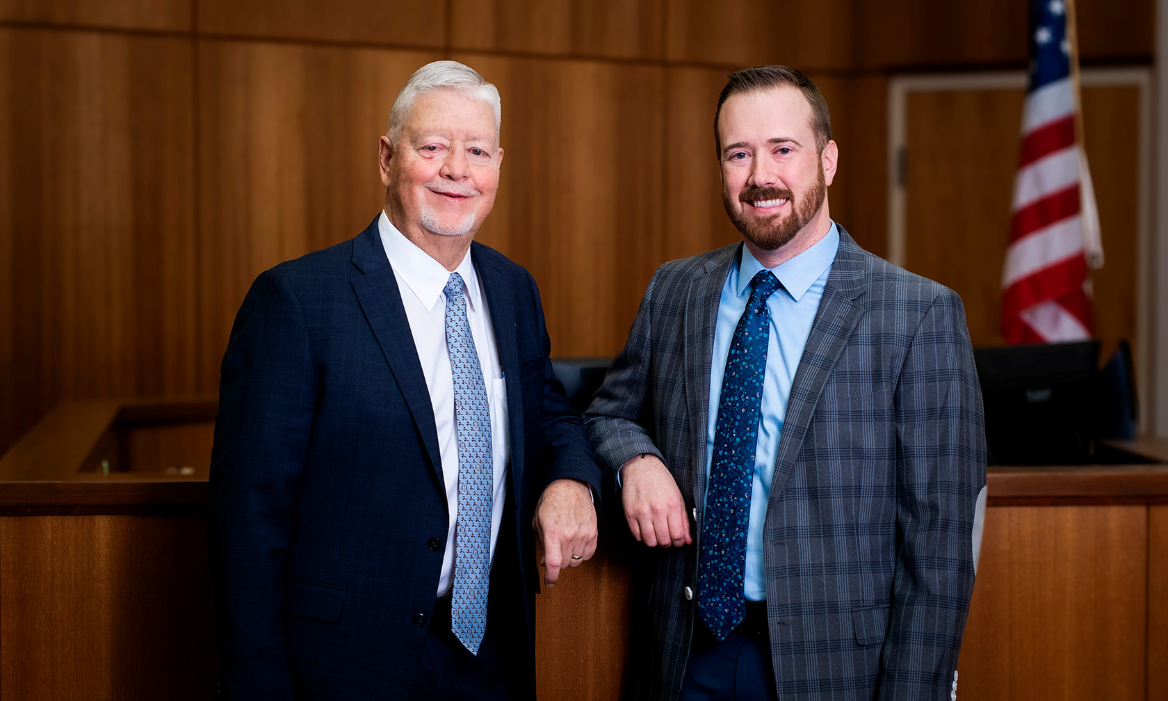 Father and son standing in courtroom