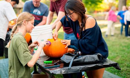 American and international students carving pumpkins