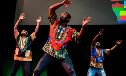 African Students wear clothes from their culture and dance on stage