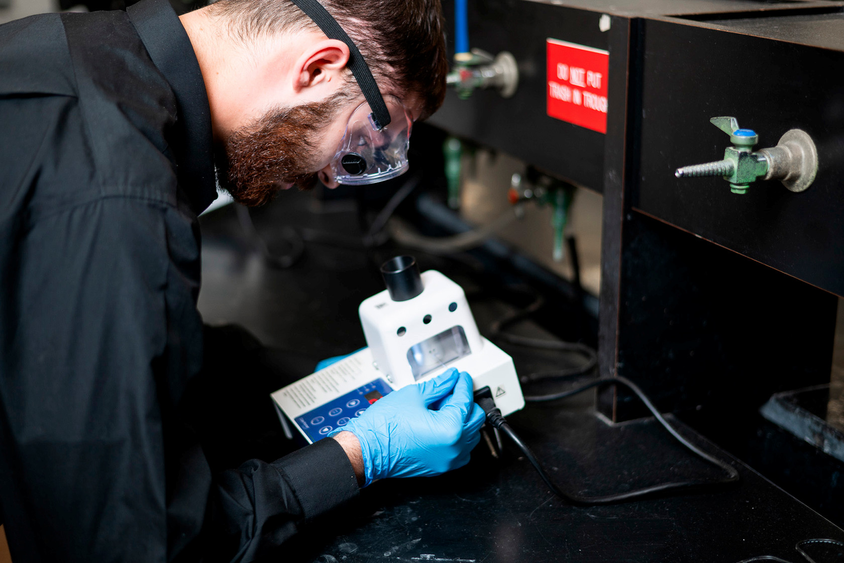 Student wearing safety goggles works 
