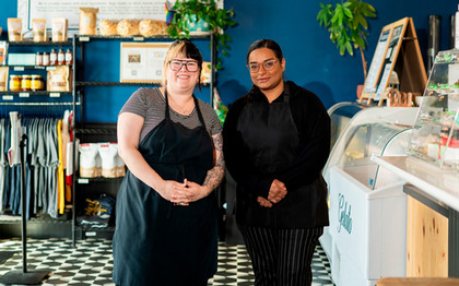 Restaurant owner and student smiling