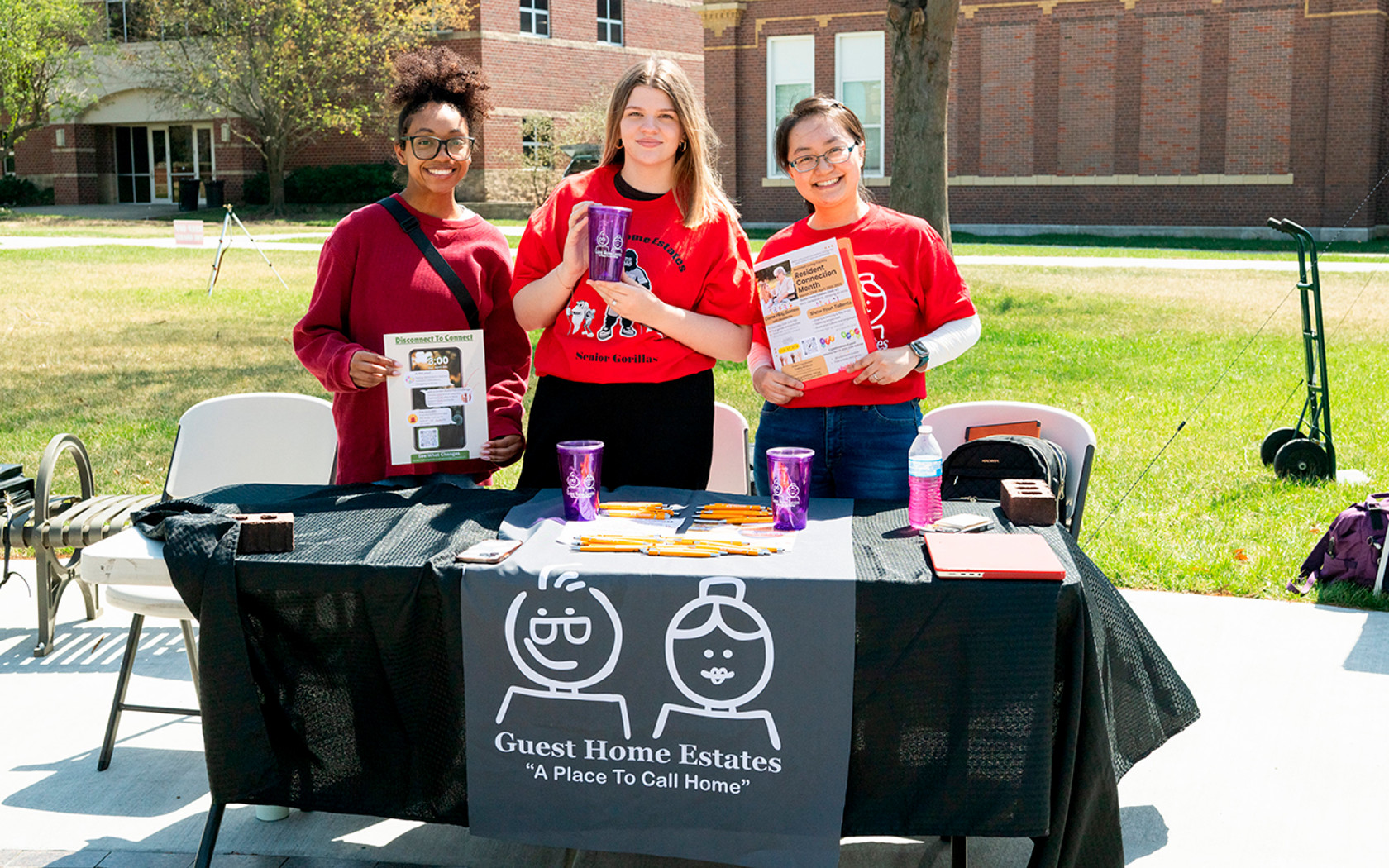 students at booth showing project