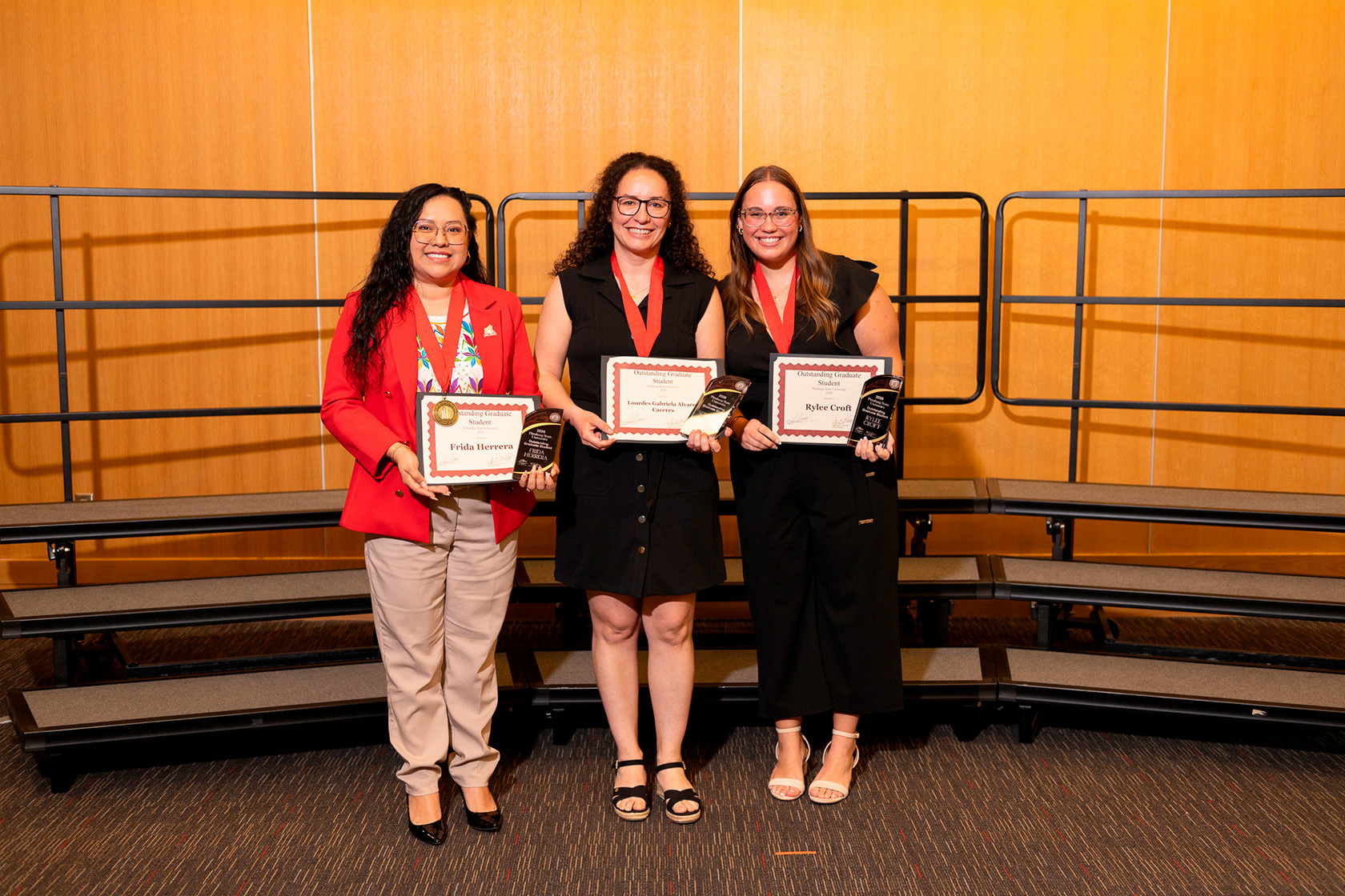 Grad students pose with their awards 