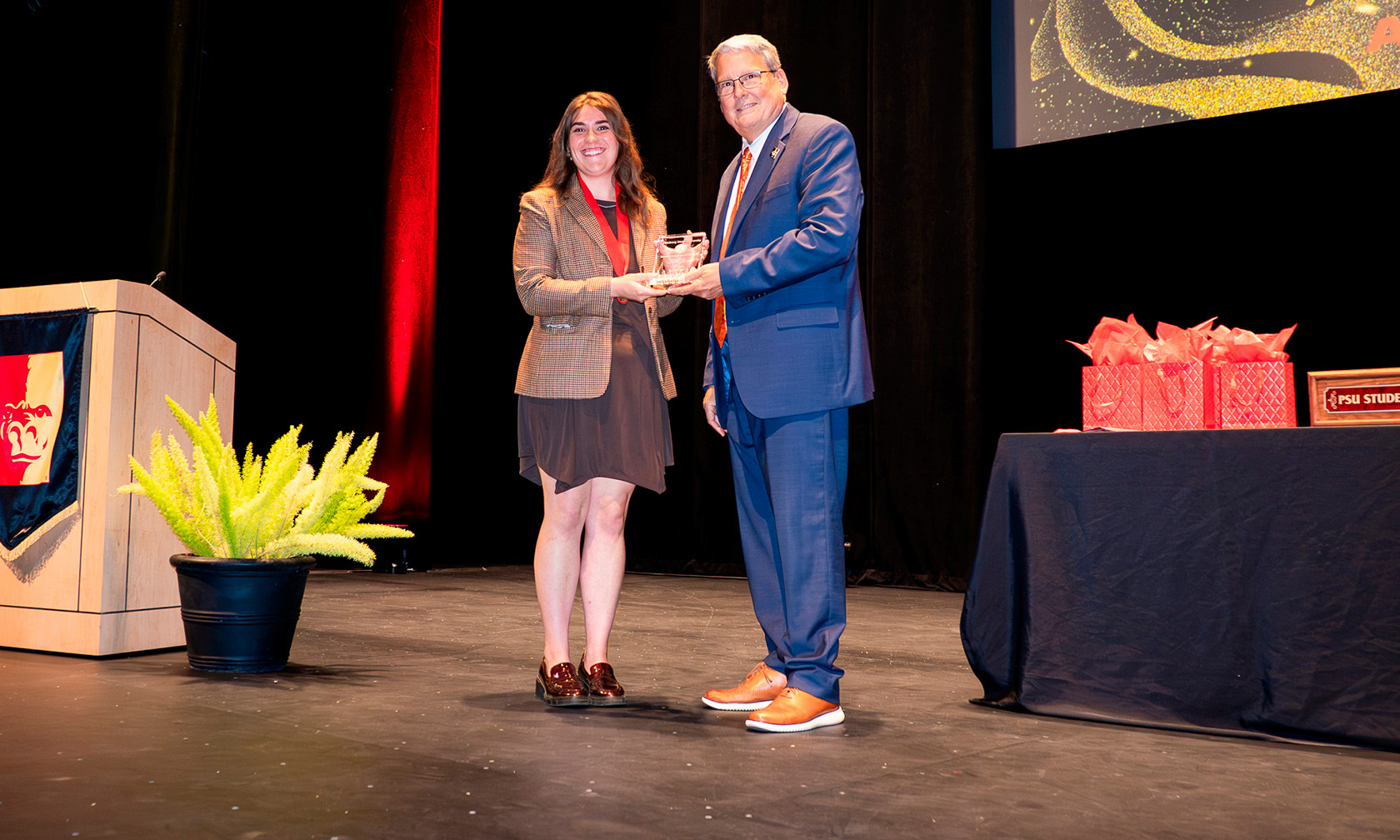 student employee of the year getting trophy from president newsom