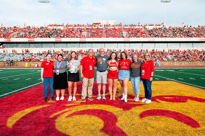 members of the family pose on the football field 