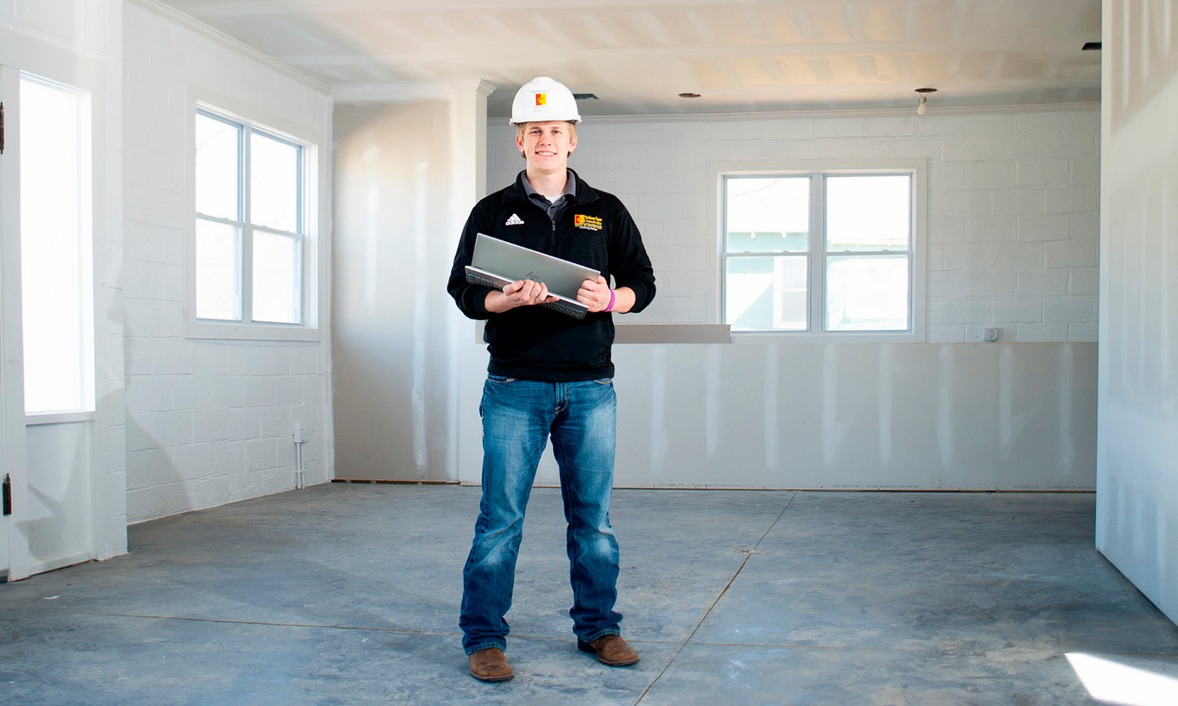 student in hard hat at construction site