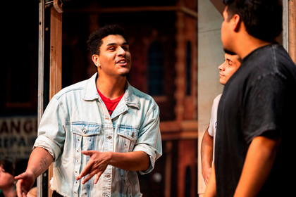 In the Heights - denim Jacket gesturing 