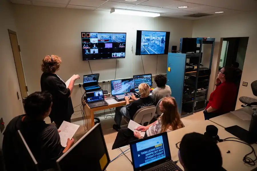 Students sit in a control room working on a live show