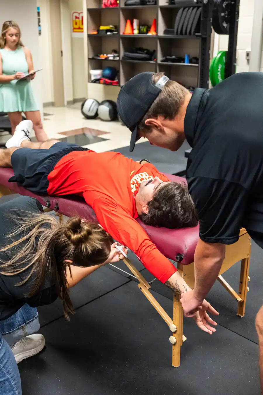 an athlete laying on a weight bench doing stretching tests