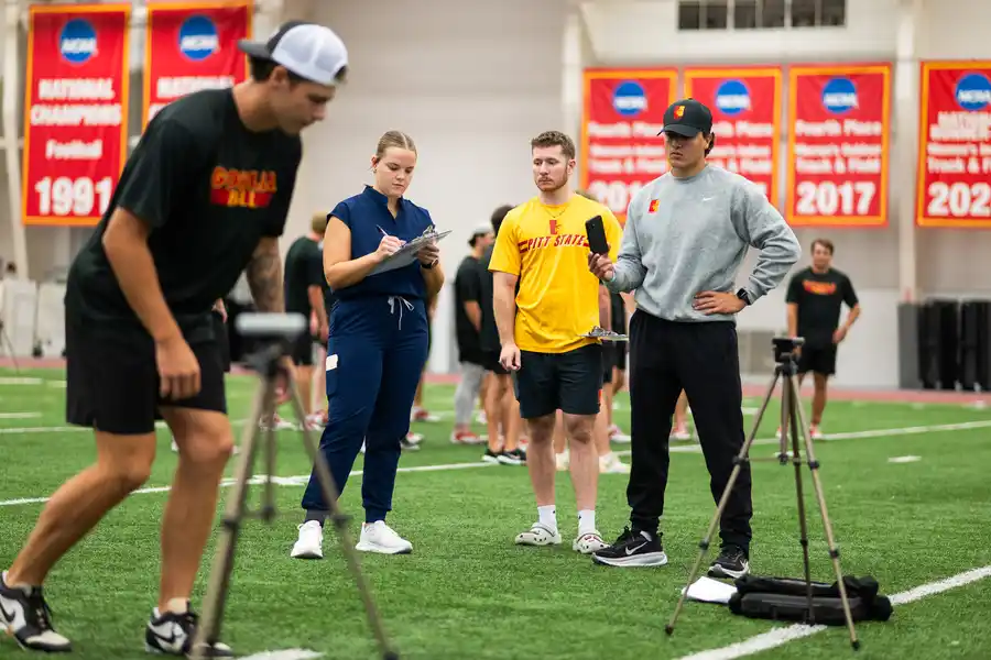 athletes doing tests on a turf field in a sports complex