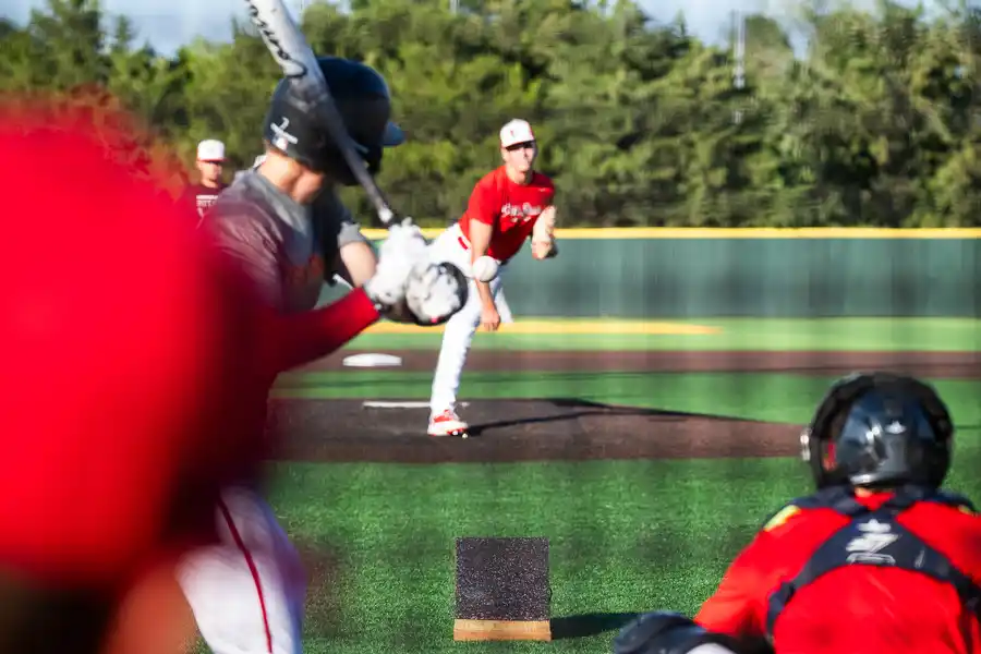 pitcher throwing baseball to batter