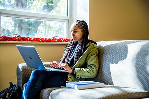 student on a computer 480w