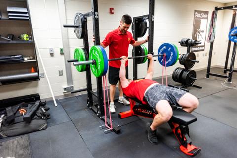 student weightlifting in human performance lab