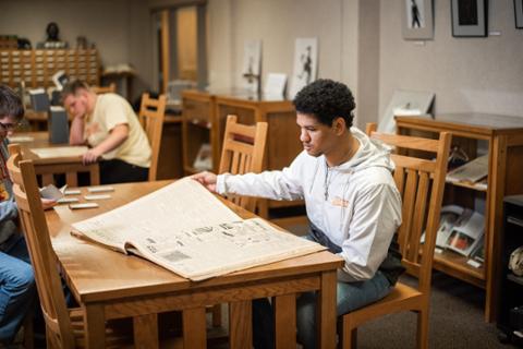 Student in photo archives of Axe Library at pittsburg state University