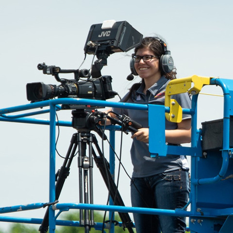 Communication major with studio camera equipment at Pittsburg State University
