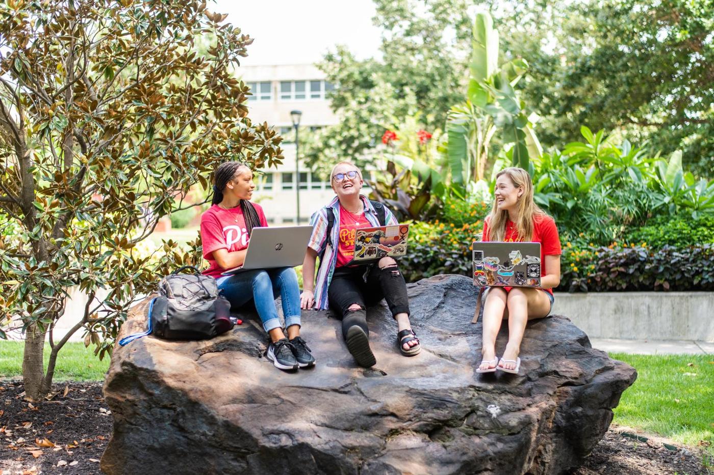 Students sitting on a rock 1400w