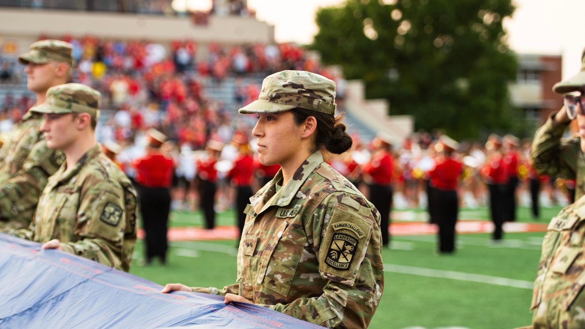 ROTC-student-holding-flag-during-game